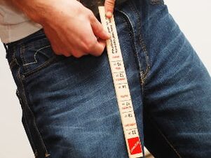 man measuring penis length